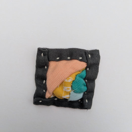Square patchwork magnet in pink, yellow, blue and grey