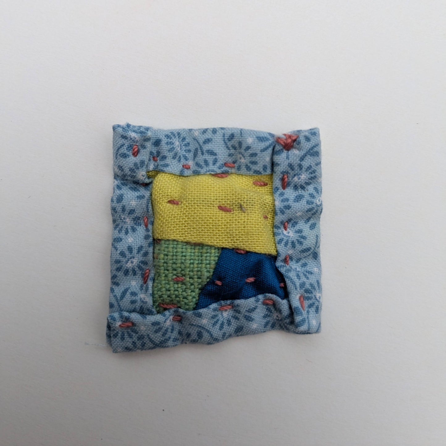 Square patchwork magnet in yellow, green, and blue