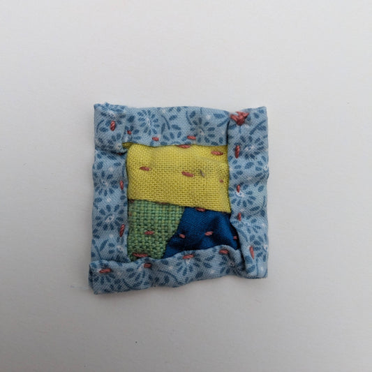Square patchwork magnet in yellow, green, and blue